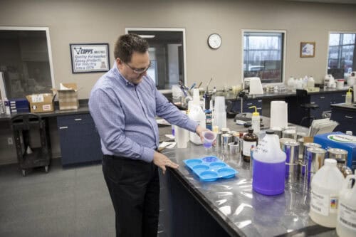 Scientist pouring resin