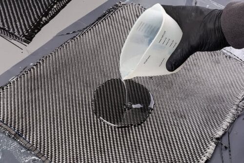 Rolls with various real woven carbon fiber enforcement raw material cloth. composite material automotive and car tuning industry high tech background.