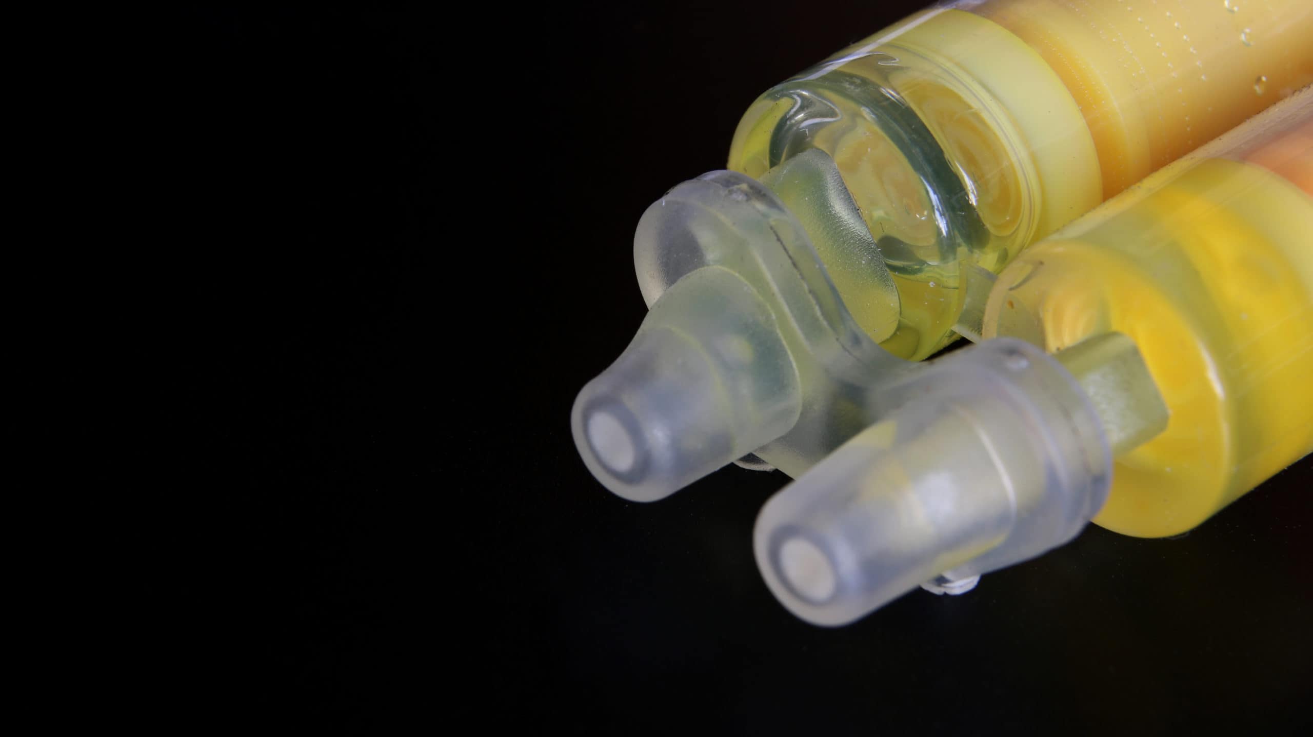 Liquid metal glue. Epoxy resin syringe isolated on black. Liquid metal glue. Epoxy resin syringe isolated on black.